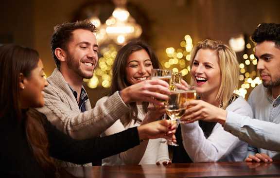 a group of people drinking wine at a bar