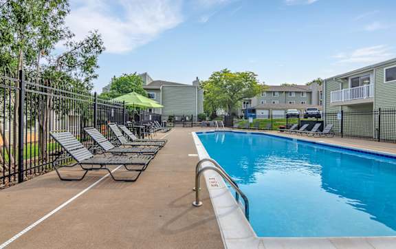 A gym with a row of treadmills and elliptical machines. at Winding Hills Apartments, Davenport, Iowa