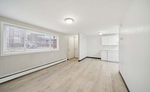 a bedroom with hardwood flooring and a large window  at ReNew End Street, Alaska, 99577