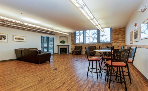 an empty living room with a table and chairs and a fireplace