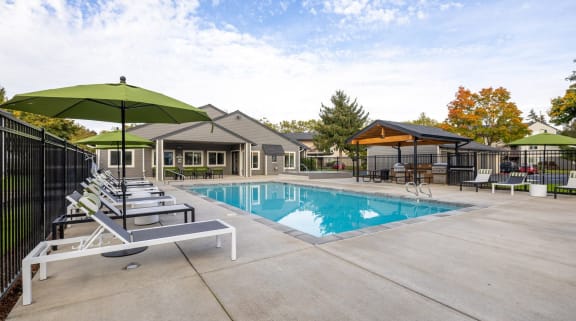Atrio Apartments Pool with Lounge Chairs