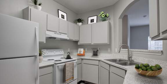 A room with a white counter and a ceiling fan.