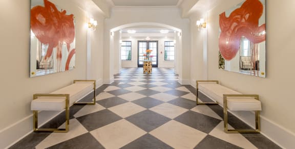 A hallway with a checkered floor and two benches. at The Roseberry Apartments in Columbia, SC