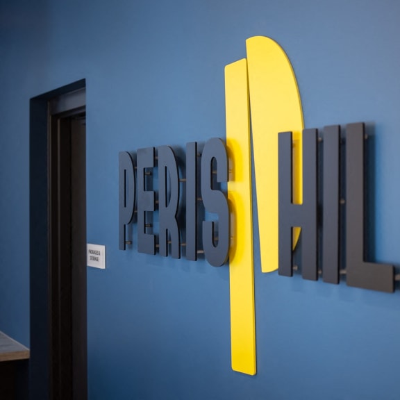 a blue wall with a sign that says design refresh on it