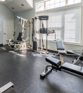 a gym with treadmills and other exercise equipment in a home