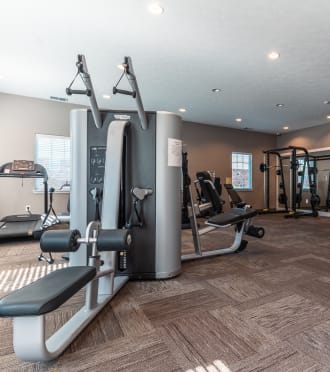 a gym with treadmills and other exercise equipment in a home