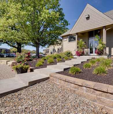 Exterior view of the clubhouse building at Olde English Village, surrounded by well-maintained landscaping and a welcoming atmosphere.