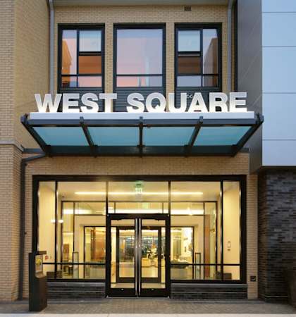 The front of a building with the words West Square on it.