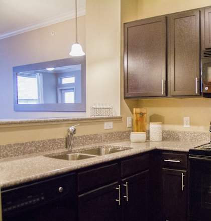 a kitchen with black appliances and granite counter tops