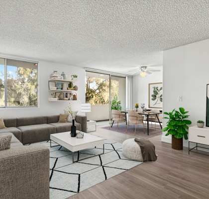 a living room with white walls and a large window
