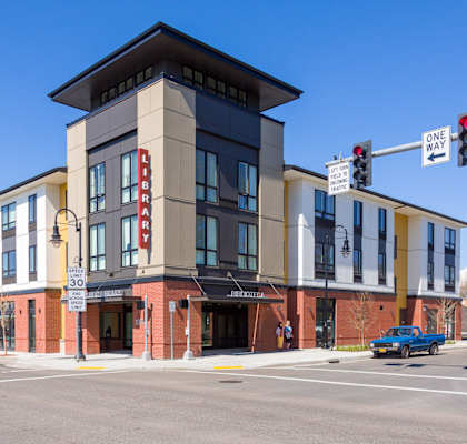 a large building on the corner of a street with a traffic light