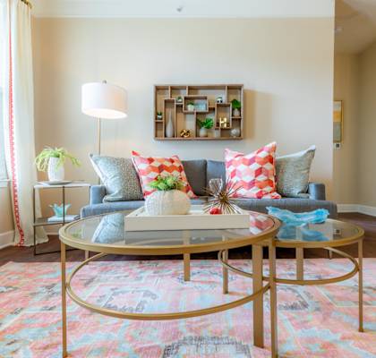 a living room with a blue couch and a coffee table at The Residences at Bluhawk Apartment Homes, Overland Park, Kansas