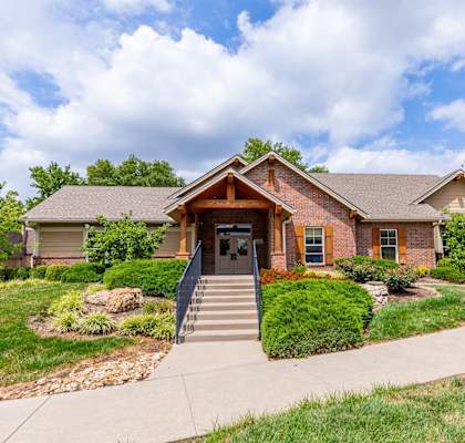 A house with a brown roof and a front porch.