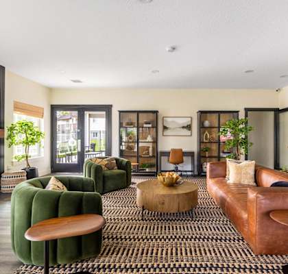 a living room with leather furniture and a fireplace