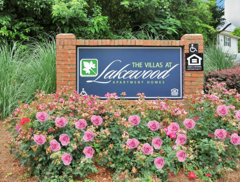 Community sign with rose bushes in front