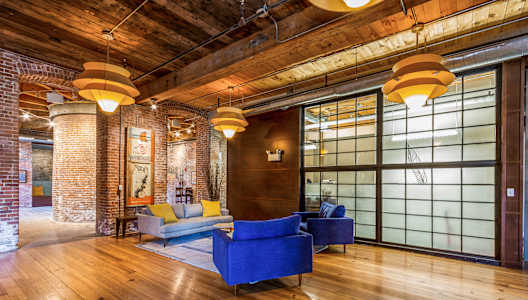 a living room with couches and chairs and a large window at Rising Sun Mills, Rhode Island, 02909
