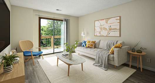 A living room with a grey couch, a blue chair, a coffee table, and a painting on the wall.
