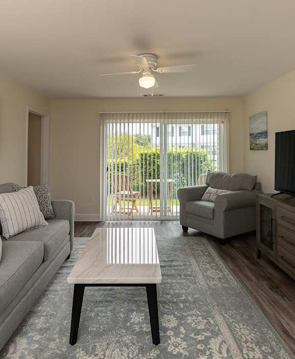 a bedroom with a large bed and a ceiling fan at The Summit at Owings Mills Apartments, Owings Mills, MD 21117