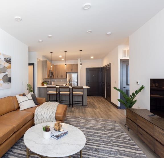 a living room with white walls and a brown couch