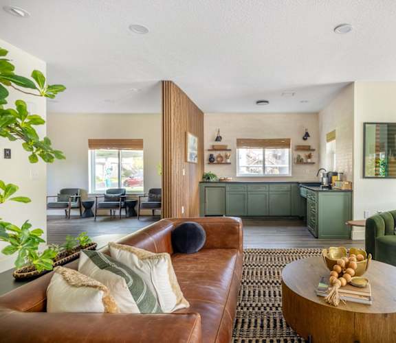 a living room with a leather couch and a coffee table