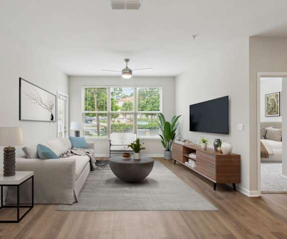 a living room with white walls and hardwood floors at Two Addison Place, Georgia, 31322