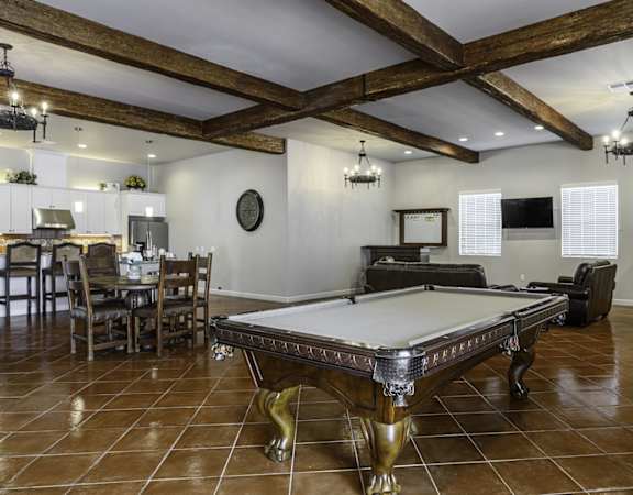 a game room with a pool table and a fireplace
