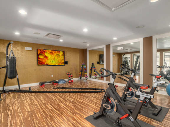 A modern living room with a large abstract painting on the wall and a wooden floor.