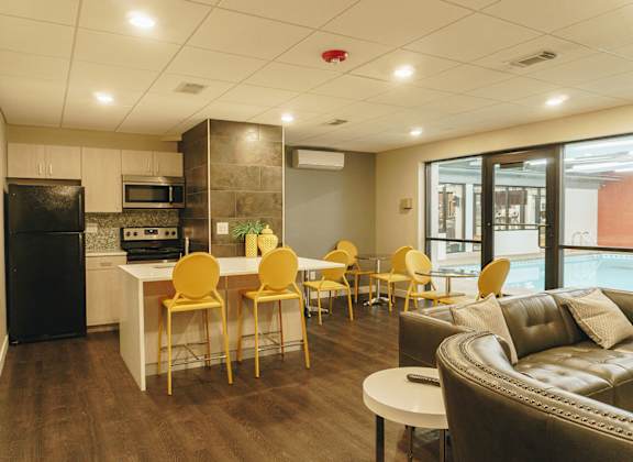 A modern kitchen with a dining table and chairs. at Astor Place of Edina Apartments , Minnesota