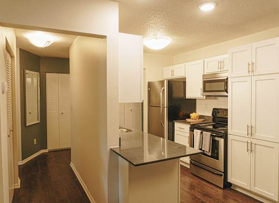 A kitchen with white cabinets and a black countertop. at Astor Place of Edina Apartments , Minnesota