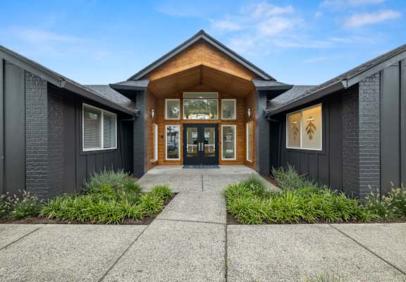 Home with black exterior and wood and brick interior at Cedar House, Vancouver