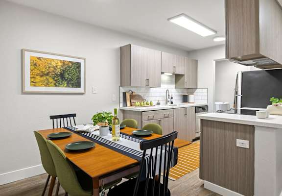 a kitchen and dining room with a table and chairs