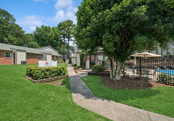 A sign in front of a building says "Welcome to Hillcrest Apartments.".