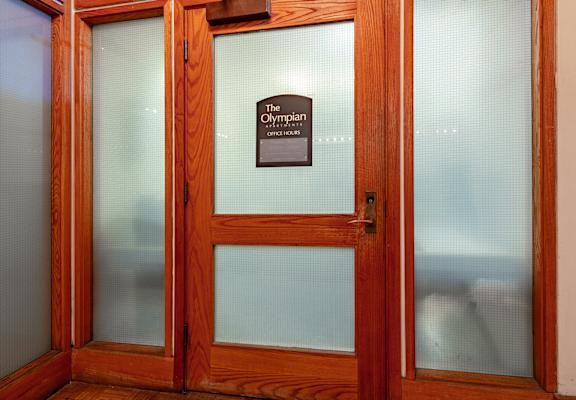 A door with a sign that says "The Olympic".