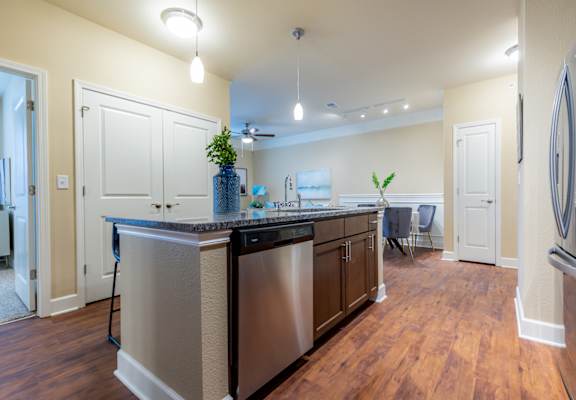 a kitchen with stainless steel appliances and a counter top at The Residences at Bluhawk Apartment Homes, Overland Park, Kansas
