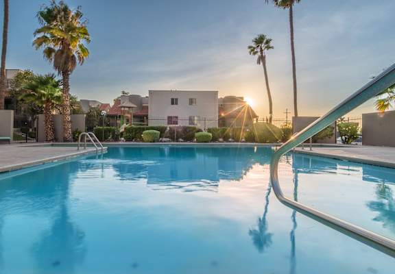 Camino Seco Village view of sparkling pool with handrail on the right side