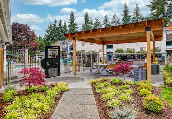 a patio with a picnic table and a gazebo