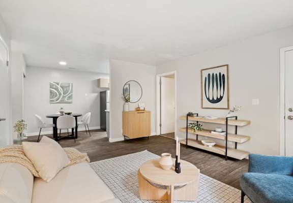 a living room with a white couch and a blue chair