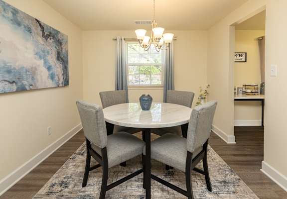 A dining room with a round table and chairs. at Colony Hill Apartments & Townhomes, Baltimore, MD, 21227