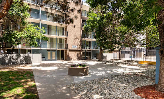 an empty courtyard in front of an apartment building