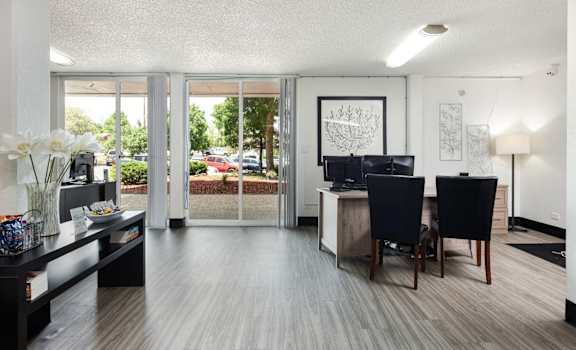 the living room and dining area of a modern apartment
