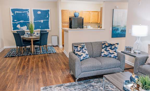 a living room and dining room with a couch and a table