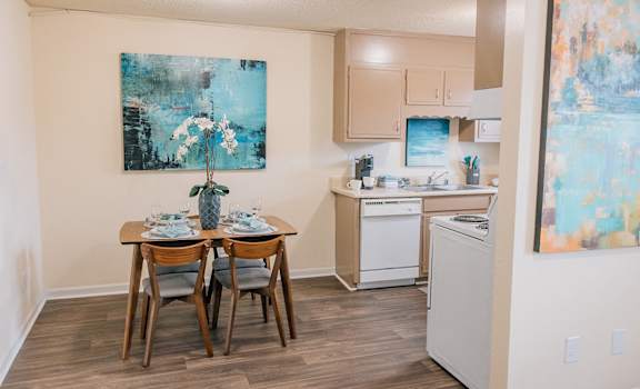 a kitchen and dining area with a table and chairs