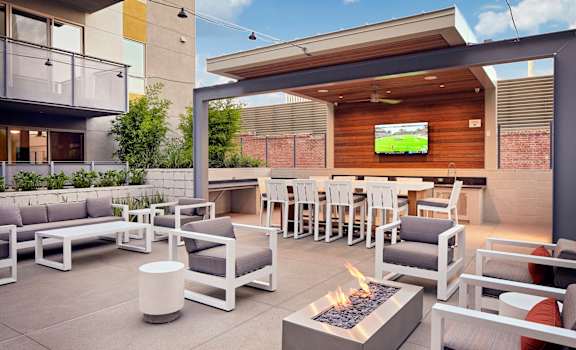outdoor lounge with firepits and TV at Main+Nine, California, 92501
