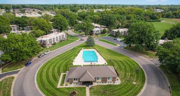 A bird's eye view of a residential area with a swimming pool.