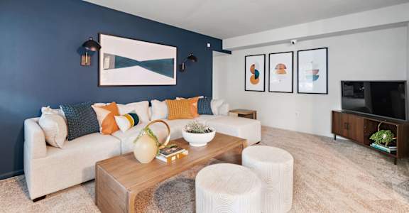 a living room with blue walls and a couch and a tv