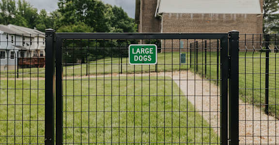 A sign on a fence reads Large Dogs.