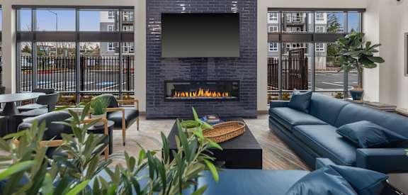 A modern living room with a fireplace and a flat screen TV.