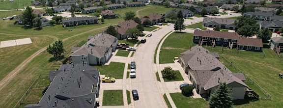 an aerial view of a neighborhood of houses with cars parked on the street  at Antelope Ridge, South Dakota, 57719