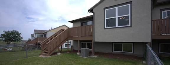 a view of the back of a house with a wooden deck  at Antelope Ridge, South Dakota, 57719
