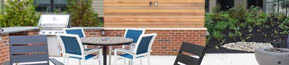 an outdoor patio with chairs and tables and a fire pit at The Yards at Malvern, Malvern, PA
